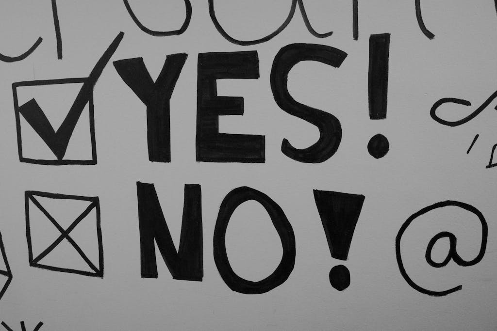Black and white artistic text with checkboxes featuring 'YES' and 'NO' in bold typography style.